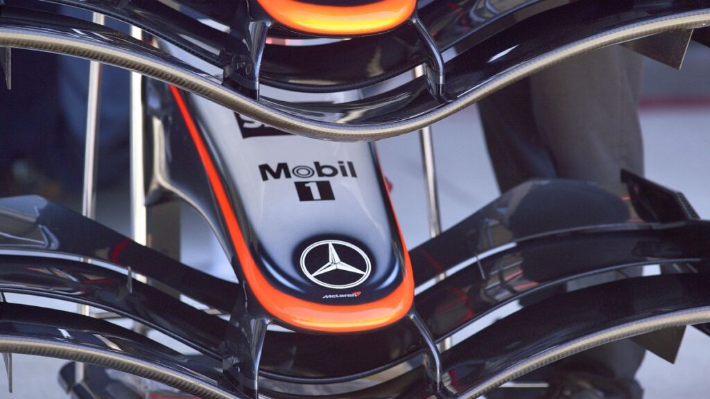 Detailed view of a Formula 1 car's front wing with Mercedes-Benz logos at Indianapolis.