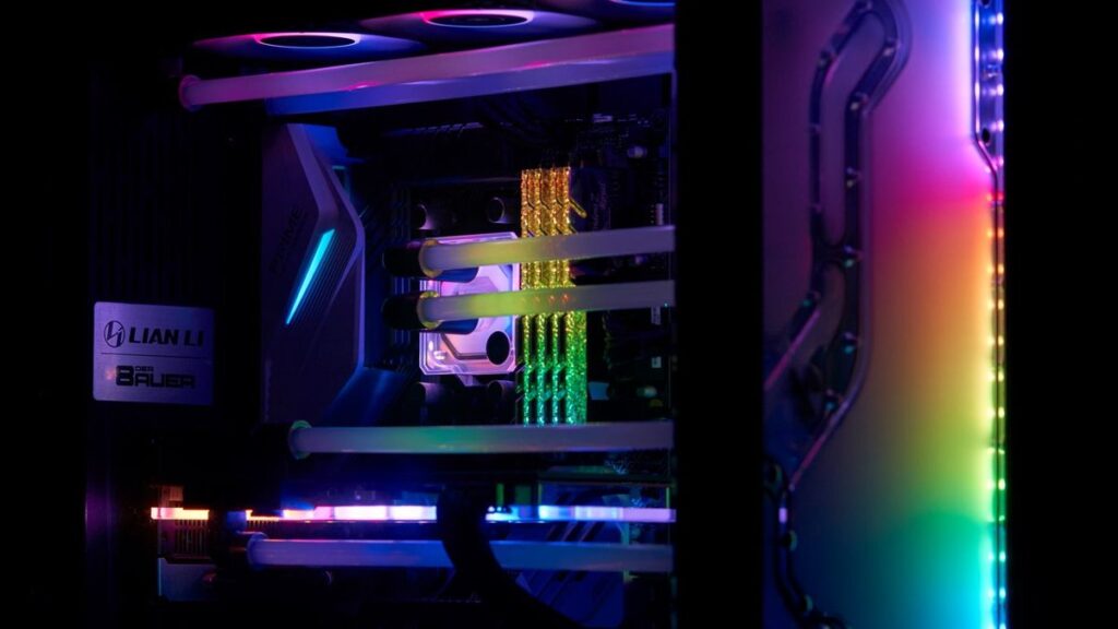 A high-performance gaming PC with vibrant RGB lighting and visible internal components.